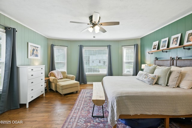 301 N 1st St, Jasper, MO 64755 - bedroom featuring crown molding, wood finished floors, ceiling fan, and wooden walls