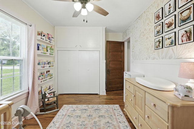 301 N 1st St, Jasper, MO 64755 - bedroom featuring crown molding, dark wood-style floors, a wainscoted wall, a closet, and ceiling fan