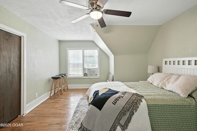 301 N 1st St, Jasper, MO 64755 - bedroom featuring wood finished floors, cooling unit, ceiling fan, and vaulted ceiling