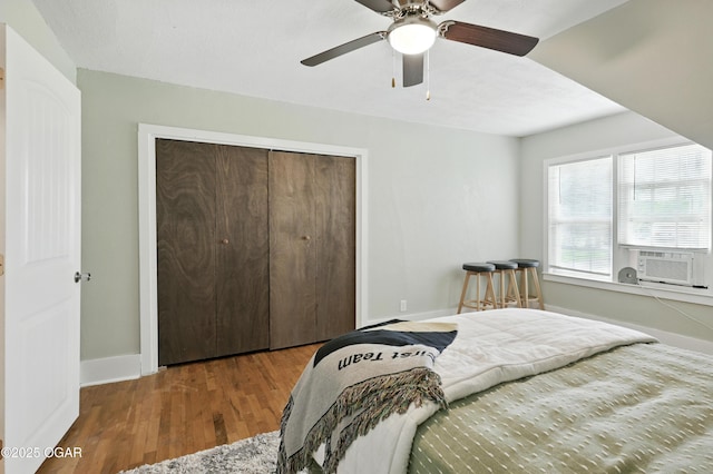 301 N 1st St, Jasper, MO 64755 - bedroom with cooling unit, a closet, wood finished floors, and a ceiling fan