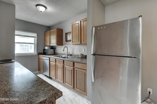 421 W 6th St, Baxter Springs, KS 66713 - kitchen featuring appliances with stainless steel finishes, a textured ceiling, and light marble finish flooring