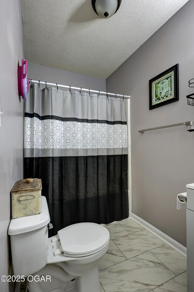 421 W 6th St, Baxter Springs, KS 66713 - full bathroom featuring marble finish flooring, a textured ceiling, and a shower with shower curtain