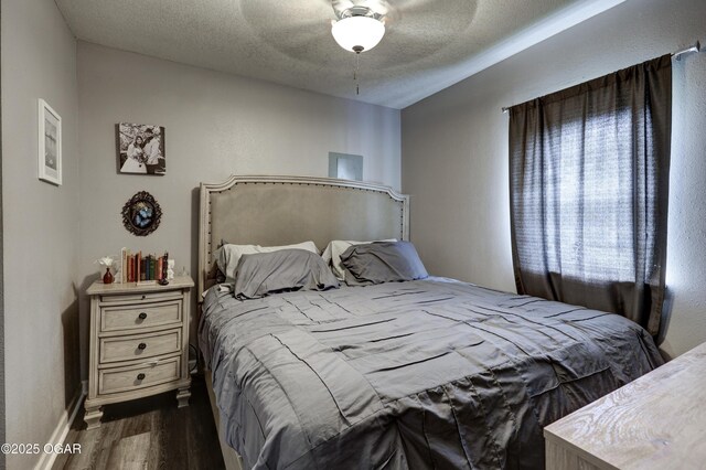 421 W 6th St, Baxter Springs, KS 66713 - bedroom with dark wood finished floors, a textured ceiling, and a ceiling fan