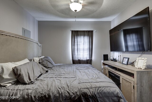 421 W 6th St, Baxter Springs, KS 66713 - bedroom with a textured ceiling and ceiling fan