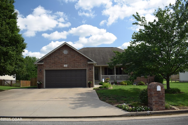 1902 E Natalie Ln, Joplin, MO 64801 - view of front of home featuring brick siding, a porch, an attached garage, and concrete driveway