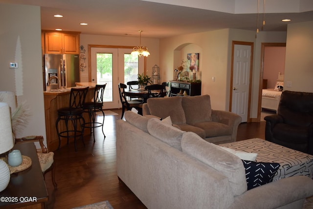 1902 E Natalie Ln, Joplin, MO 64801 - living room with dark wood finished floors, recessed lighting, arched walkways, and a chandelier