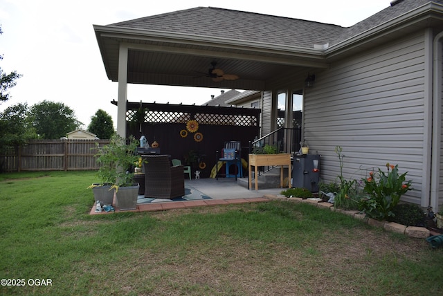 1902 E Natalie Ln, Joplin, MO 64801 - fenced backyard with ceiling fan and a patio