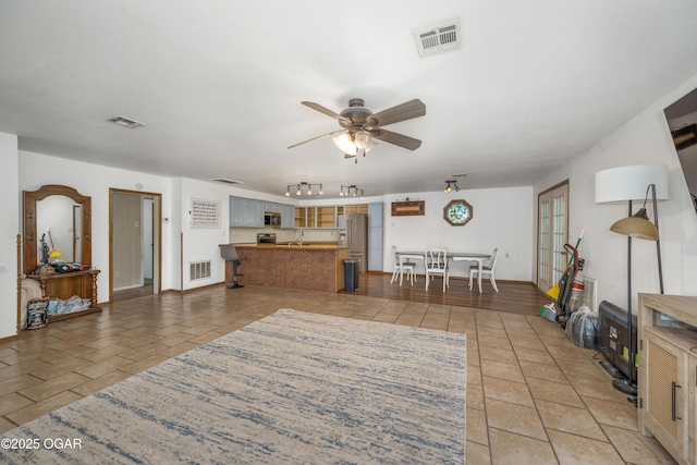 645 Worth St, Granby, MO 64844 - living area featuring ceiling fan, light tile patterned flooring, and rail lighting