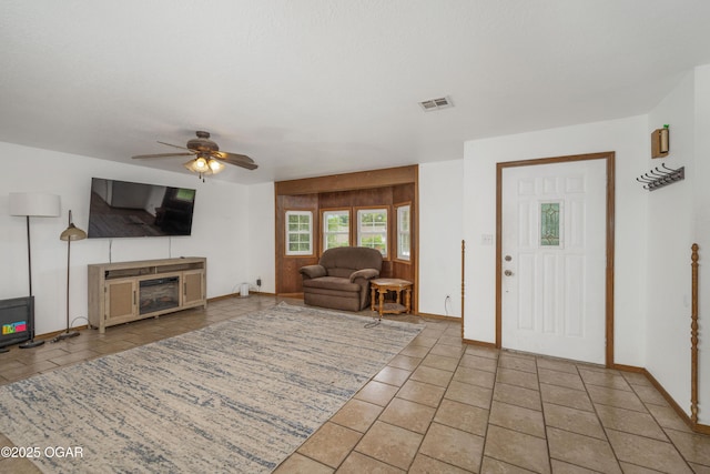 645 Worth St, Granby, MO 64844 - living area with ceiling fan, tile patterned flooring, and a fireplace