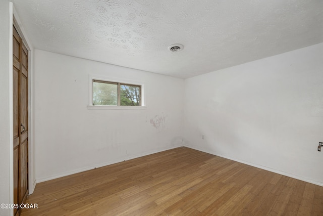 645 Worth St, Granby, MO 64844 - unfurnished bedroom featuring light wood finished floors, a textured ceiling, and a closet