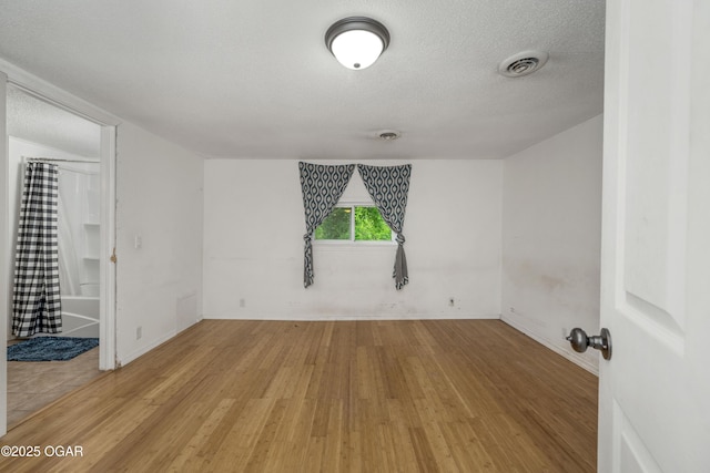 645 Worth St, Granby, MO 64844 - unfurnished room featuring light wood-style flooring and a textured ceiling