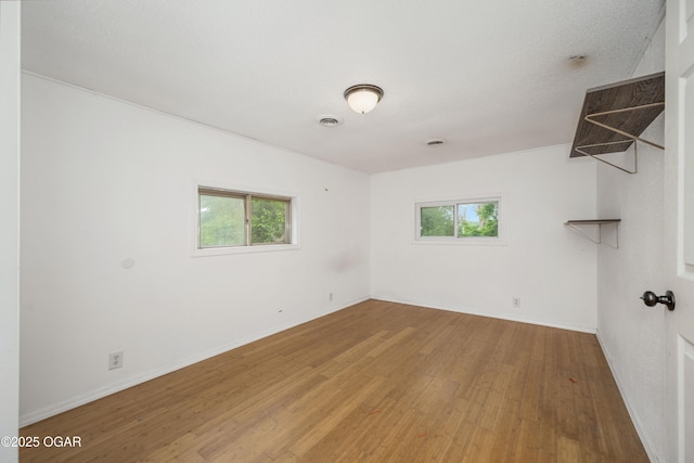 645 Worth St, Granby, MO 64844 - empty room with wood finished floors and plenty of natural light