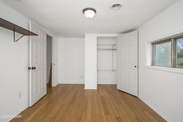 645 Worth St, Granby, MO 64844 - unfurnished bedroom with light wood-style flooring and a closet