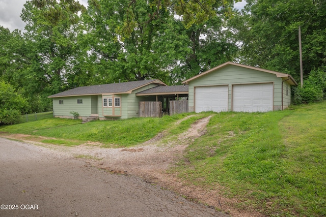 645 Worth St, Granby, MO 64844 - ranch-style home featuring a detached garage