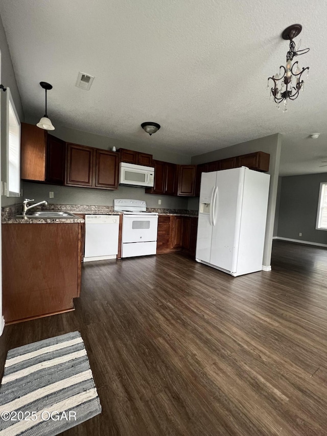 2124 S Byers Ave, Joplin, MO 64804 - kitchen with white appliances, dark wood finished floors, a textured ceiling, pendant lighting, and open floor plan