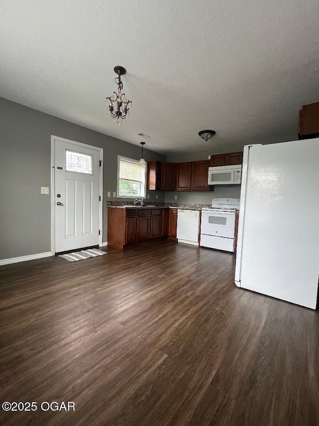 2124 S Byers Ave, Joplin, MO 64804 - kitchen featuring white appliances, a textured ceiling, dark wood-type flooring, decorative light fixtures, and a chandelier