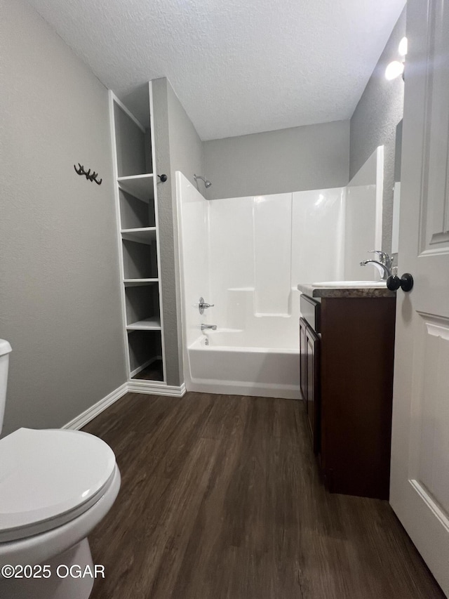 2124 S Byers Ave, Joplin, MO 64804 - bathroom featuring wood finished floors, vanity, shower / bath combination, and a textured ceiling