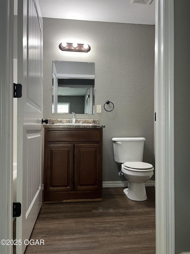 2124 S Byers Ave, Joplin, MO 64804 - bathroom featuring wood finished floors, vanity, and a textured wall