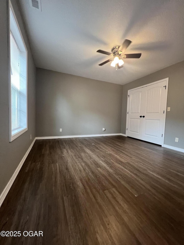 2124 S Byers Ave, Joplin, MO 64804 - unfurnished bedroom with dark wood-style floors, a ceiling fan, and a closet