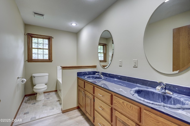 6181 County Lane 306, Carl Junction, MO 64834 - bathroom featuring double vanity and a tub to relax in