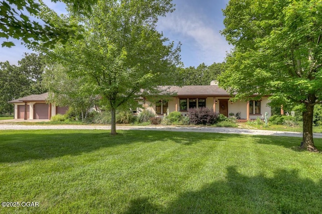 10640 Durango Ln, Carthage, MO 64836 - view of front of home featuring a front yard, a chimney, a garage, and driveway