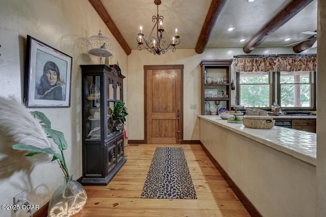 10640 Durango Ln, Carthage, MO 64836 - foyer featuring beam ceiling, a chandelier, and light wood-style floors