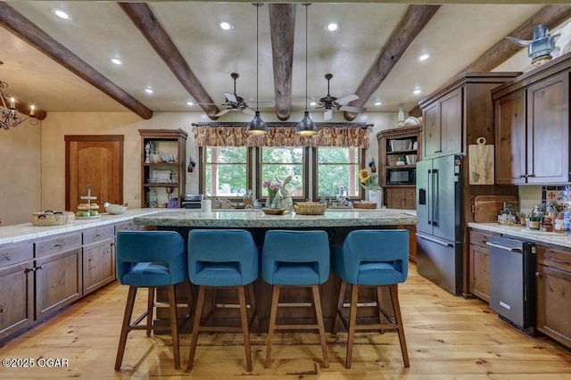 10640 Durango Ln, Carthage, MO 64836 - kitchen with stainless steel appliances, light wood-type flooring, a kitchen breakfast bar, beamed ceiling, and recessed lighting