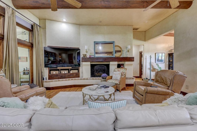 10640 Durango Ln, Carthage, MO 64836 - living room with a ceiling fan, wood finished floors, and a fireplace with raised hearth
