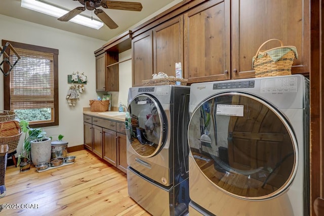 10640 Durango Ln, Carthage, MO 64836 - washroom featuring separate washer and dryer, cabinet space, and light wood-style flooring