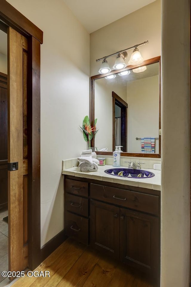10640 Durango Ln, Carthage, MO 64836 - bathroom with vanity and wood finished floors