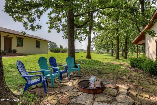 10640 Durango Ln, Carthage, MO 64836 - view of green lawn with an outdoor fire pit and a patio area