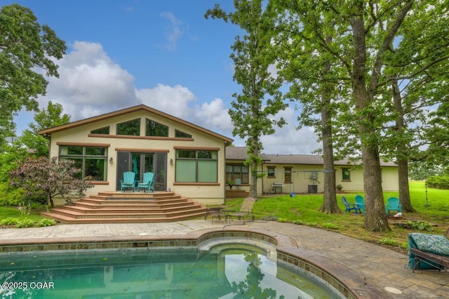 10640 Durango Ln, Carthage, MO 64836 - back of property featuring stucco siding, a patio area, and an outdoor pool