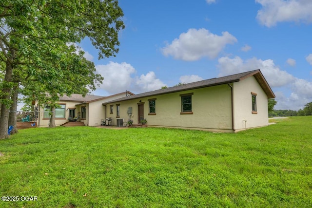 10640 Durango Ln, Carthage, MO 64836 - back of house featuring stucco siding and a yard
