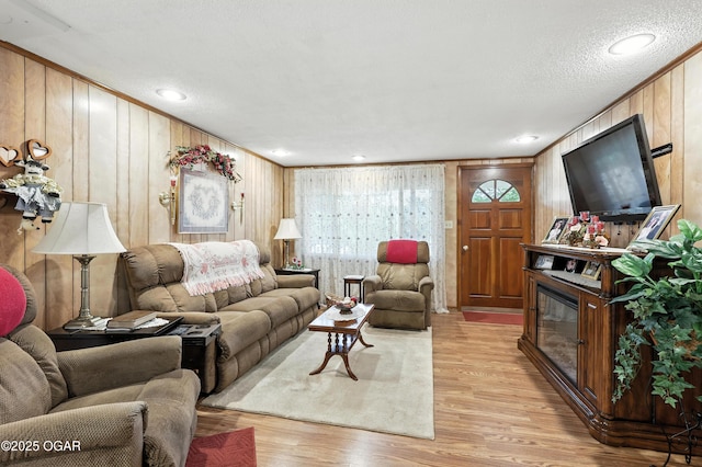 2015 W Zora St, Joplin, MO 64801 - living area with light wood finished floors, wooden walls, and a textured ceiling