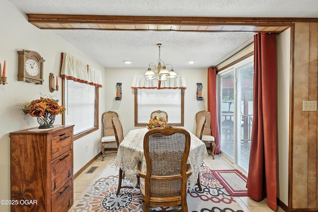 2015 W Zora St, Joplin, MO 64801 - dining space with a chandelier, a textured ceiling, and light tile patterned flooring