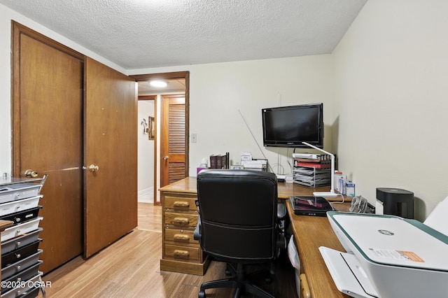 2015 W Zora St, Joplin, MO 64801 - home office with light wood-style flooring and a textured ceiling