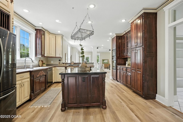 509 W Highland Ave, Carthage, MO 64836 - kitchen featuring freestanding refrigerator, plenty of natural light, light wood-style floors, ornamental molding, and recessed lighting