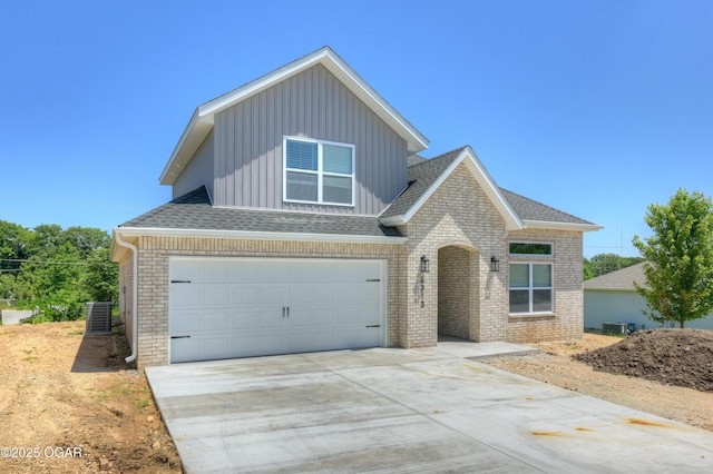 4313 W 28th Pl, Joplin, MO 64804 - traditional-style house featuring board and batten siding, an attached garage, driveway, and brick siding