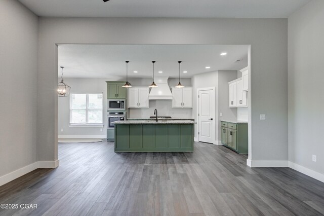 4313 W 28th Pl, Joplin, MO 64804 - kitchen featuring appliances with stainless steel finishes, green cabinets, custom exhaust hood, dark wood-style flooring, and recessed lighting