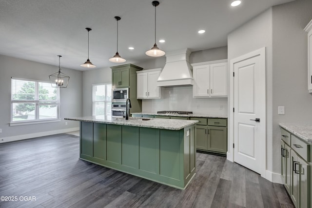 4313 W 28th Pl, Joplin, MO 64804 - kitchen with premium range hood, appliances with stainless steel finishes, dark wood-style flooring, recessed lighting, and an island with sink