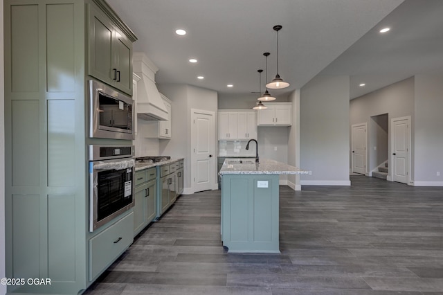 4313 W 28th Pl, Joplin, MO 64804 - kitchen featuring appliances with stainless steel finishes, premium range hood, recessed lighting, a kitchen island with sink, and light stone counters