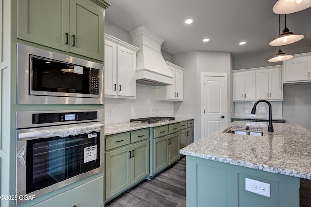 4313 W 28th Pl, Joplin, MO 64804 - kitchen with stainless steel appliances, green cabinets, dark wood-type flooring, backsplash, and recessed lighting