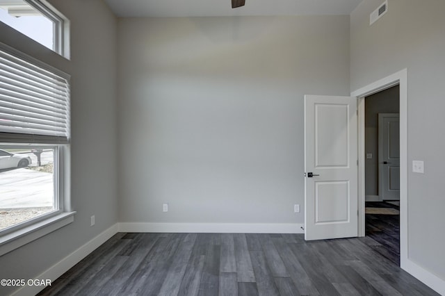 4313 W 28th Pl, Joplin, MO 64804 - unfurnished room with dark wood-style floors, a ceiling fan, and a towering ceiling