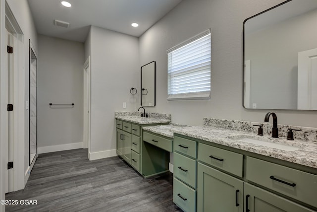 4313 W 28th Pl, Joplin, MO 64804 - full bath featuring two vanities, wood finished floors, a stall shower, and recessed lighting
