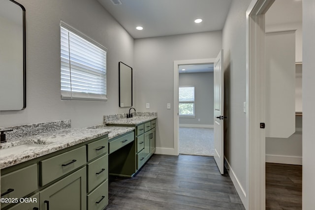 4313 W 28th Pl, Joplin, MO 64804 - full bath featuring wood finished floors, two vanities, recessed lighting, and a spacious closet
