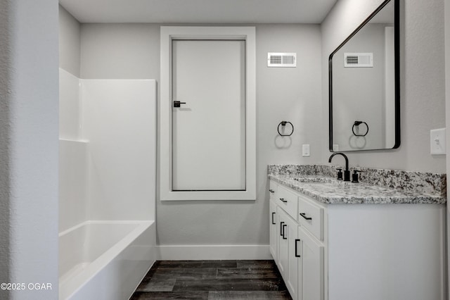 4313 W 28th Pl, Joplin, MO 64804 - bathroom featuring wood finished floors, vanity, and  shower combination