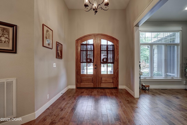 6133 Ridgeview Ct, Joplin, MO 64804 - foyer with healthy amount of natural light, a chandelier, hardwood / wood-style flooring, and french doors