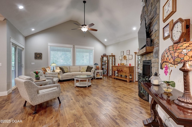 6133 Ridgeview Ct, Joplin, MO 64804 - living area with a stone fireplace, high vaulted ceiling, ceiling fan, plenty of natural light, and light wood-type flooring
