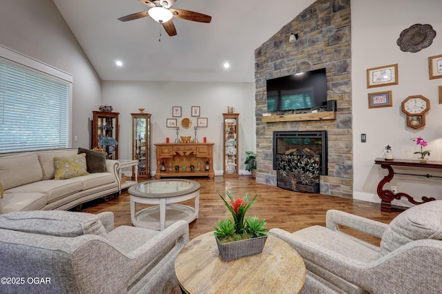 6133 Ridgeview Ct, Joplin, MO 64804 - living area with ceiling fan, wood finished floors, high vaulted ceiling, a stone fireplace, and recessed lighting