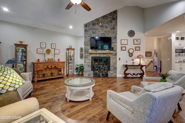 6133 Ridgeview Ct, Joplin, MO 64804 - living area with a ceiling fan, wood finished floors, a stone fireplace, recessed lighting, and high vaulted ceiling